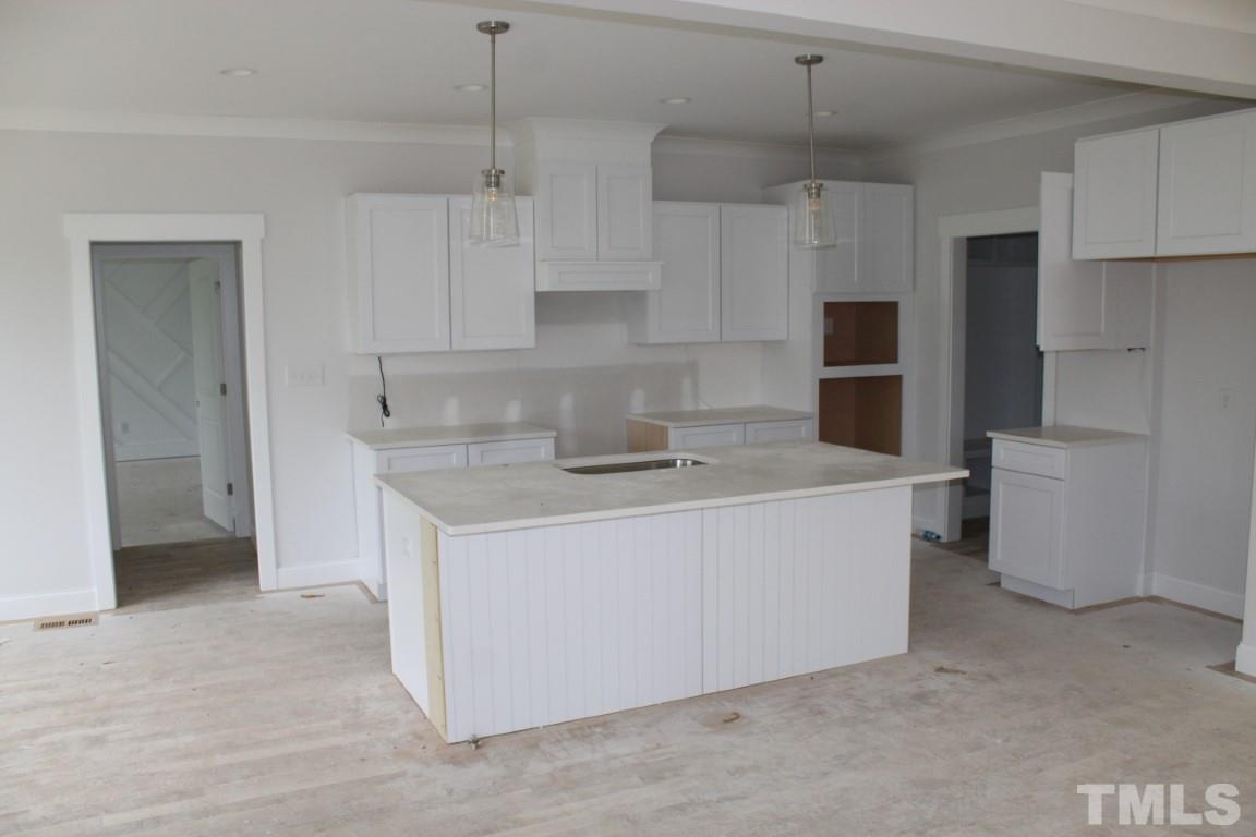 320 Prides Crossing Rolesville, NC 27571 - Photo 3 of 23 a kitchen with stainless steel appliances granite countertop a sink a stove a refrigerator and cabinets