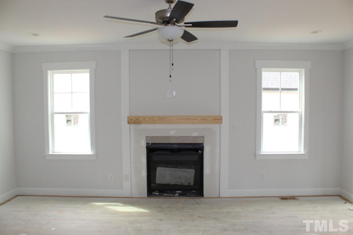 320 Prides Crossing Rolesville, NC 27571 - Photo 5 of 23 an empty room with windows and a fireplace