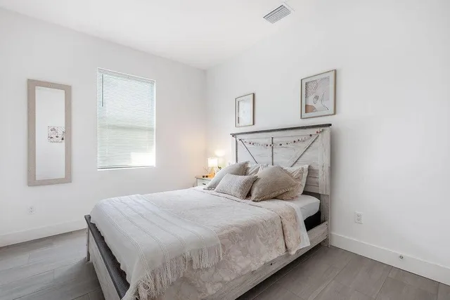 a bedroom with a bed and night stand