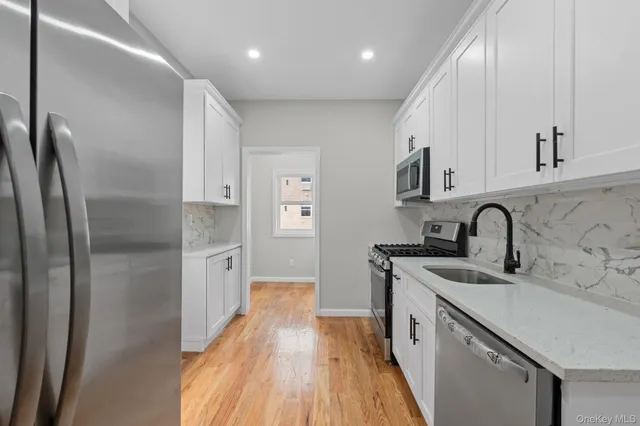 a kitchen with stainless steel appliances a sink stove and refrigerator