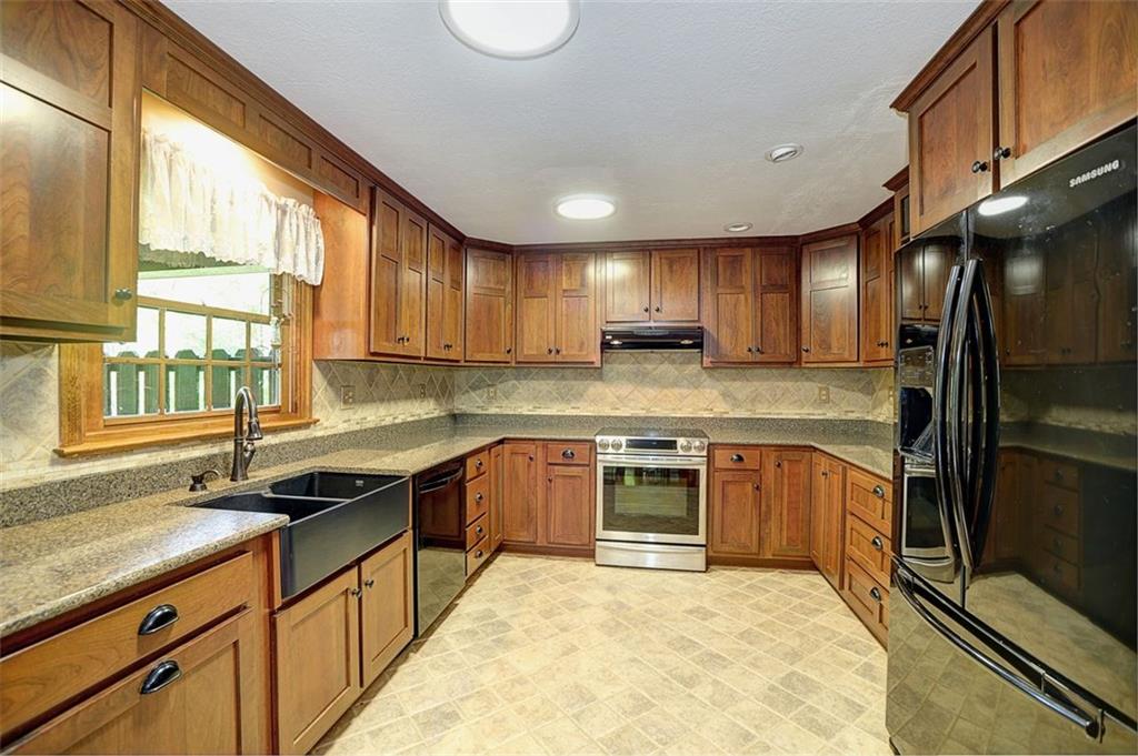 130 Ridgeview Lane Harmony, PA 16037 - Photo 11 of 24 Updated Kitchen w/ Cherry Cabinets, Quartz counters, farm sink & ceramic floor.
