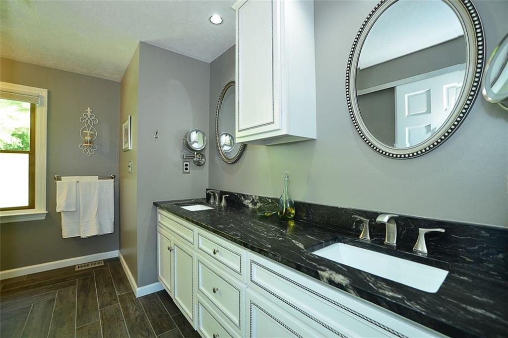 130 Ridgeview Lane Harmony, PA 16037 - Photo 14 of 24 2017 updated Master Bath features granite counter top w/ dual sinks/mirrors in new cabinets, recessed overhead lighting, ceramic tile fashion planked flooring and (2) privacy windows.
