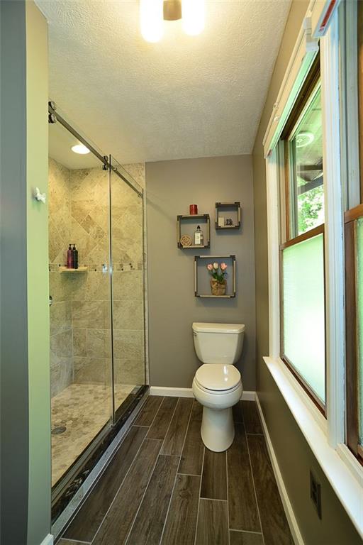 130 Ridgeview Lane Harmony, PA 16037 - Photo 15 of 24 View2 of the Master Bath shows LARGE standing shower w/ custom tile work and top-quality glass enclosure & toilet.