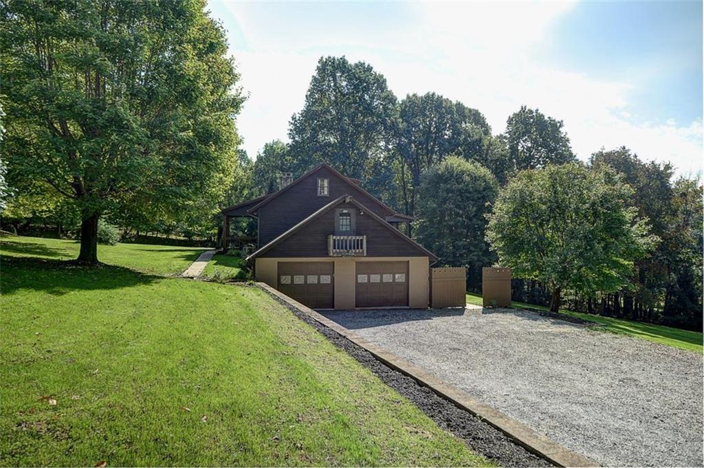 130 Ridgeview Lane Harmony, PA 16037 - Photo 3 of 24 Large driveway easily parks multiple vehicles. 2 car garage w/ rear-facing Man door. Bonus Bedroom4 above the garage with separate heating/cooling system.