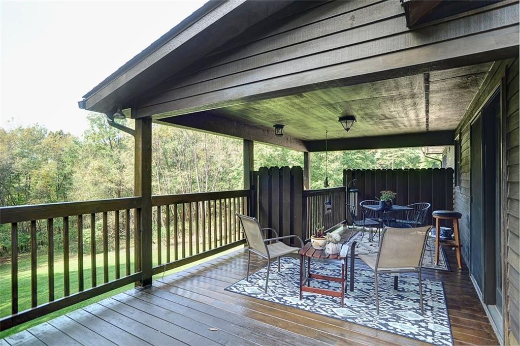 130 Ridgeview Lane Harmony, PA 16037 - Photo 4 of 24 This section of the rear deck highlights the covered section that's accessed by glass door from the Dining Room.