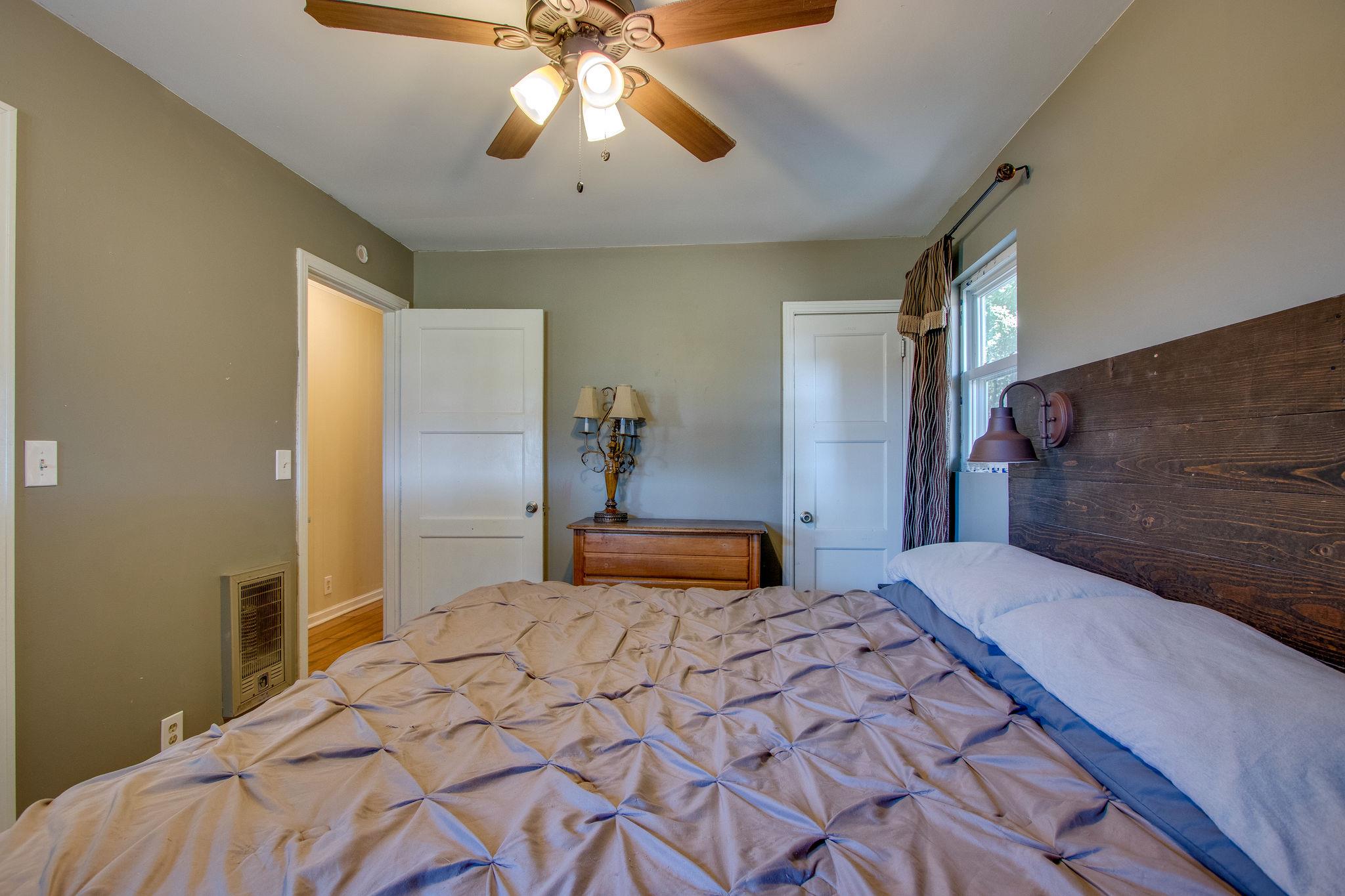 2461 Old Shannon Road Lebanon, TN 37090 - Photo 14 of 30 a bedroom with a bed and a chandelier