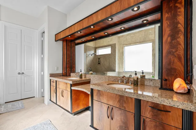 a bedroom with a bed a flat screen tv and a large mirror