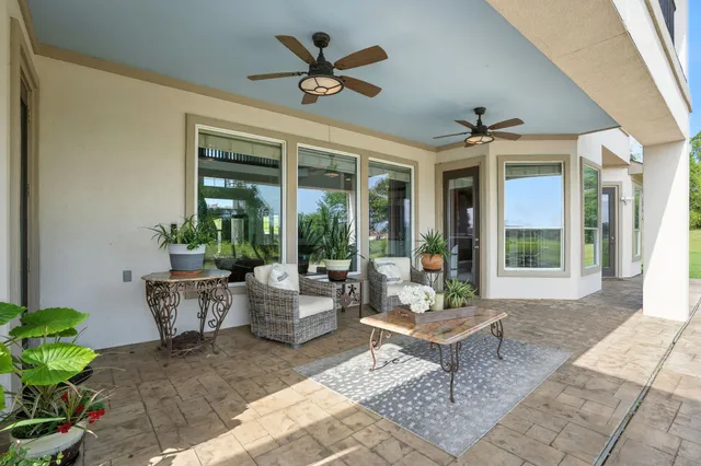 a view of a balcony with furniture and a lake view