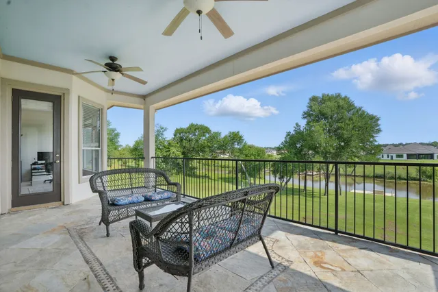 a view of a dining room with furniture a chandelier and wooden floor