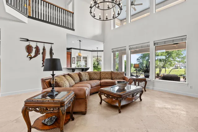 a large kitchen with kitchen island a large counter space a sink stainless steel appliances and cabinets
