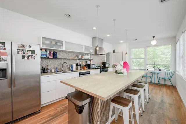 a kitchen with stainless steel appliances granite countertop a sink dishwasher stove and cabinets