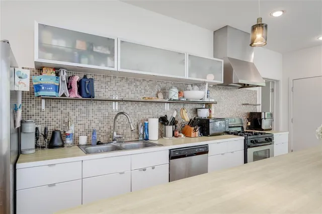 a kitchen with a sink and a stove