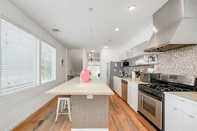 a living room with furniture a flat screen tv and a large window