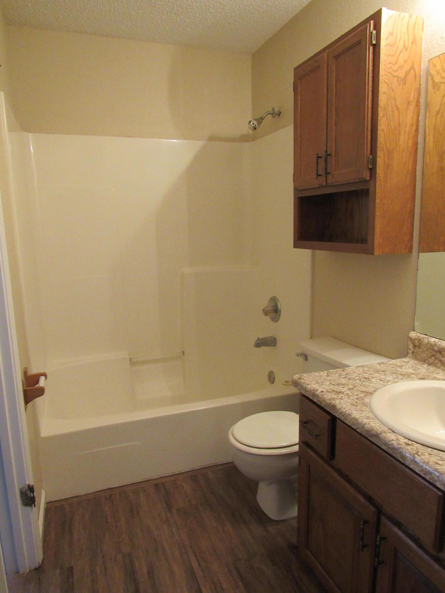 713 Valley Road Crestview, FL 32539 - Photo 13 of 17 a bathroom with a granite countertop toilet a sink and a bathtub