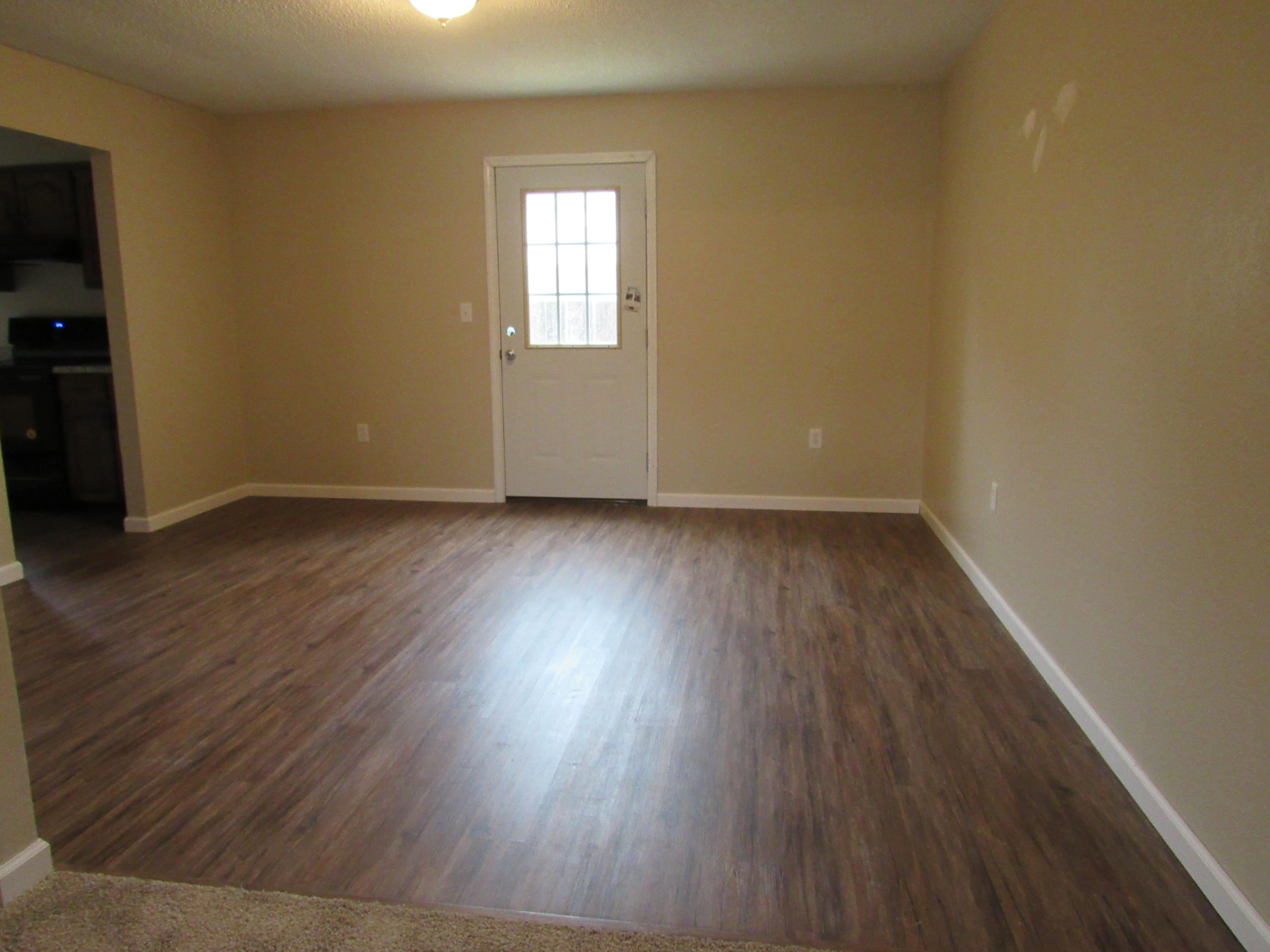 713 Valley Road Crestview, FL 32539 - Photo 16 of 17 an empty room with wooden floor and windows