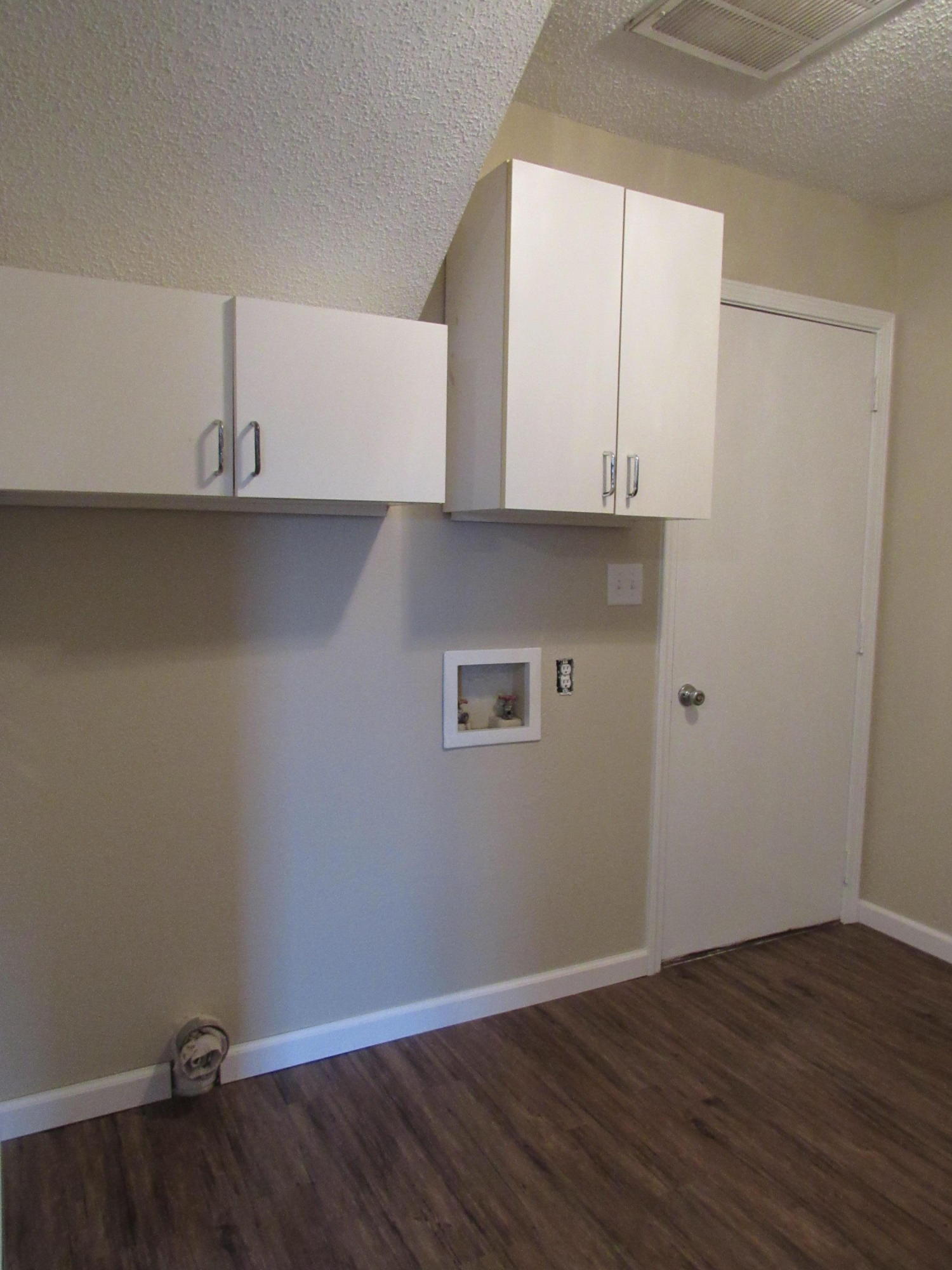 713 Valley Road Crestview, FL 32539 - Photo 17 of 17 an empty room with wooden floor and cabinet