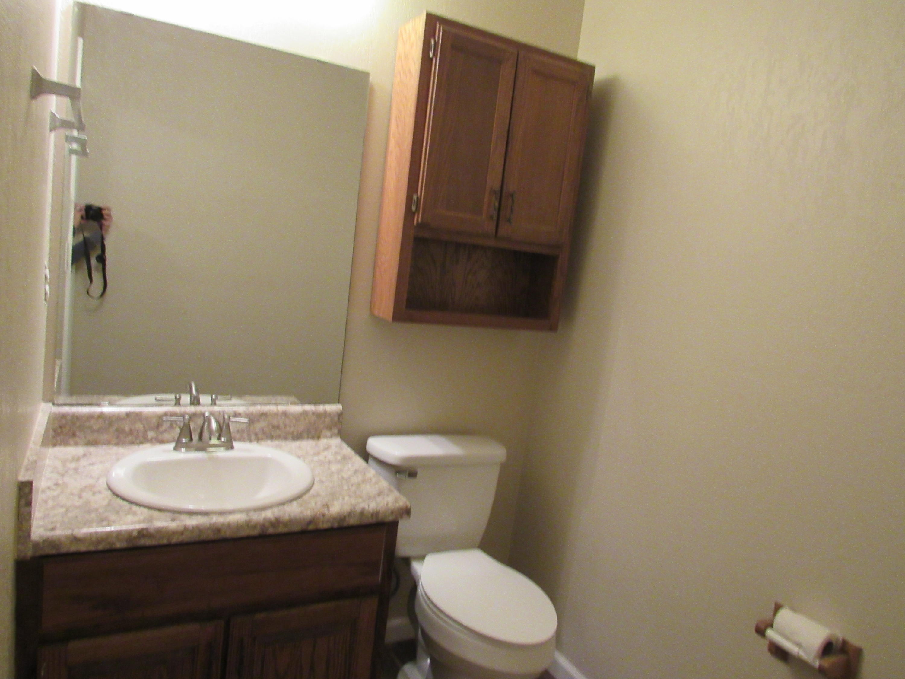 713 Valley Road Crestview, FL 32539 - Photo 9 of 17 a bathroom with a granite countertop toilet sink and mirror