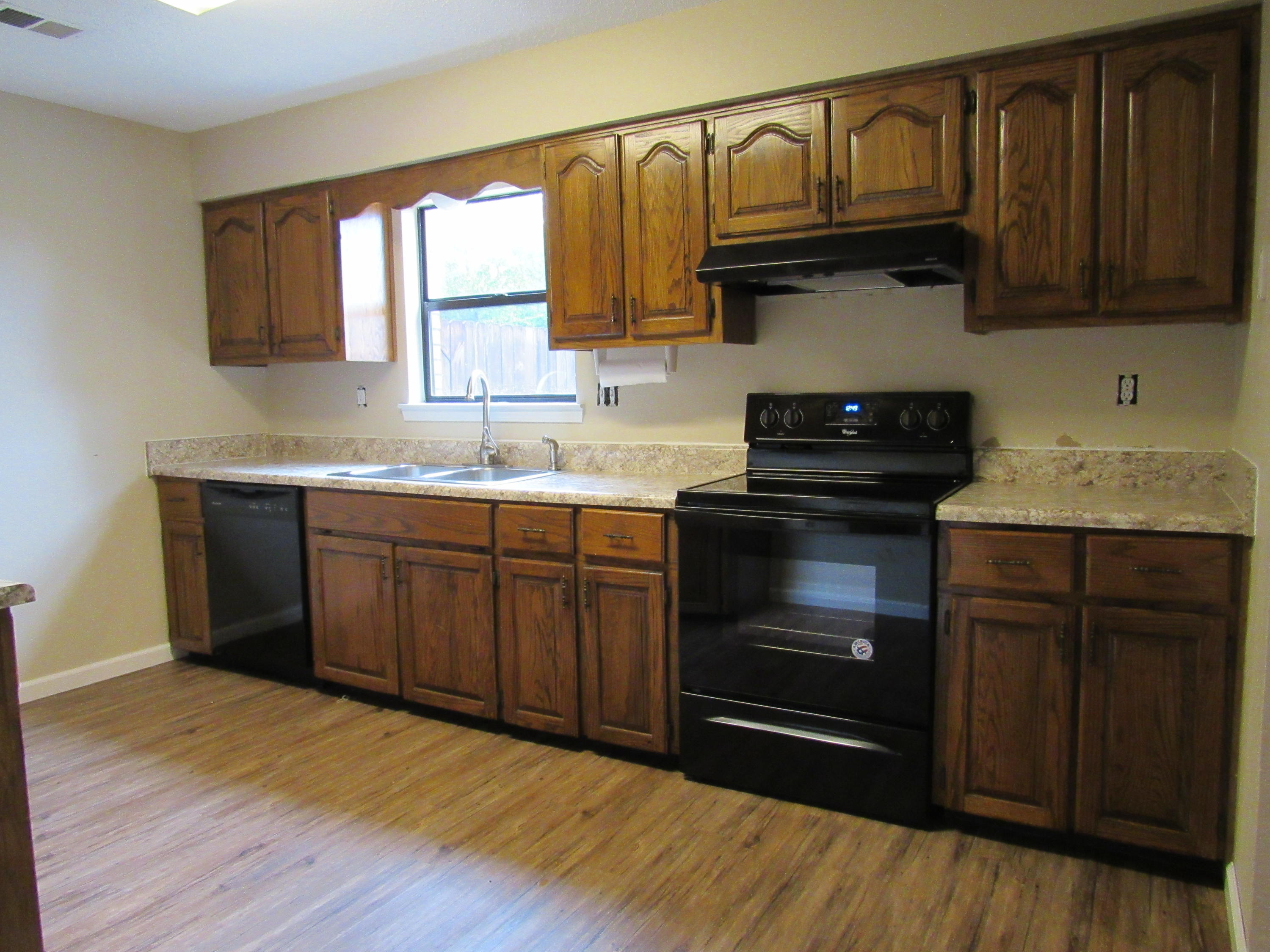 713 Valley Road Crestview, FL 32539 - Photo 10 of 17 a kitchen with granite countertop wooden cabinets and a stove top oven