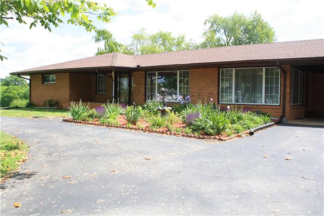 322 Long Road Ardmore, TN 38449 - Photo 1 of 20 Front View of Home - Showing the carport, asphalt drive and beautiful landscaping.