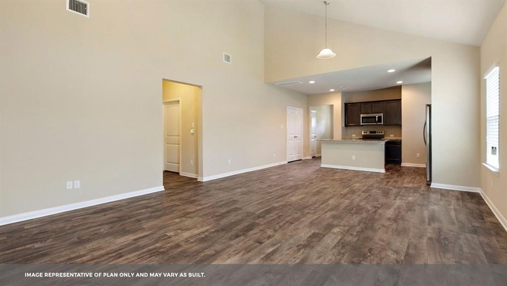 14909 Custis Lane Austin, TX 78725 - Photo 19 of 21 a view of a kitchen with a sink and a refrigerator