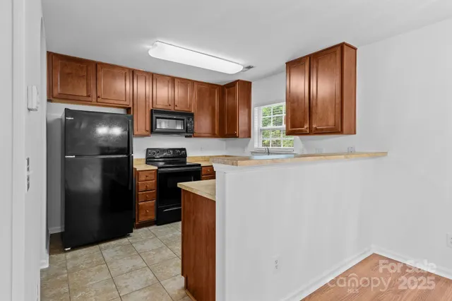 a kitchen with a refrigerator and a stove
