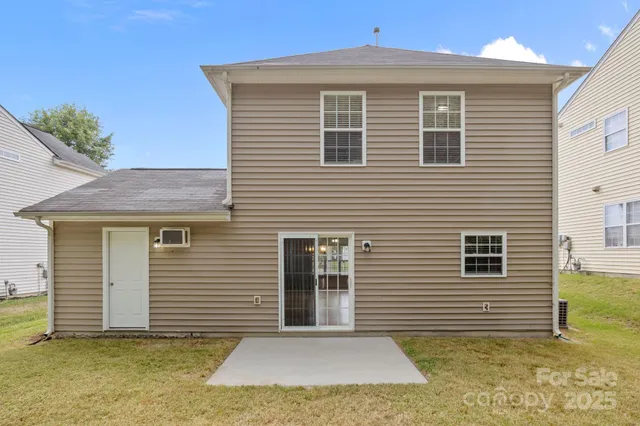 a view of a house with more windows and a yard