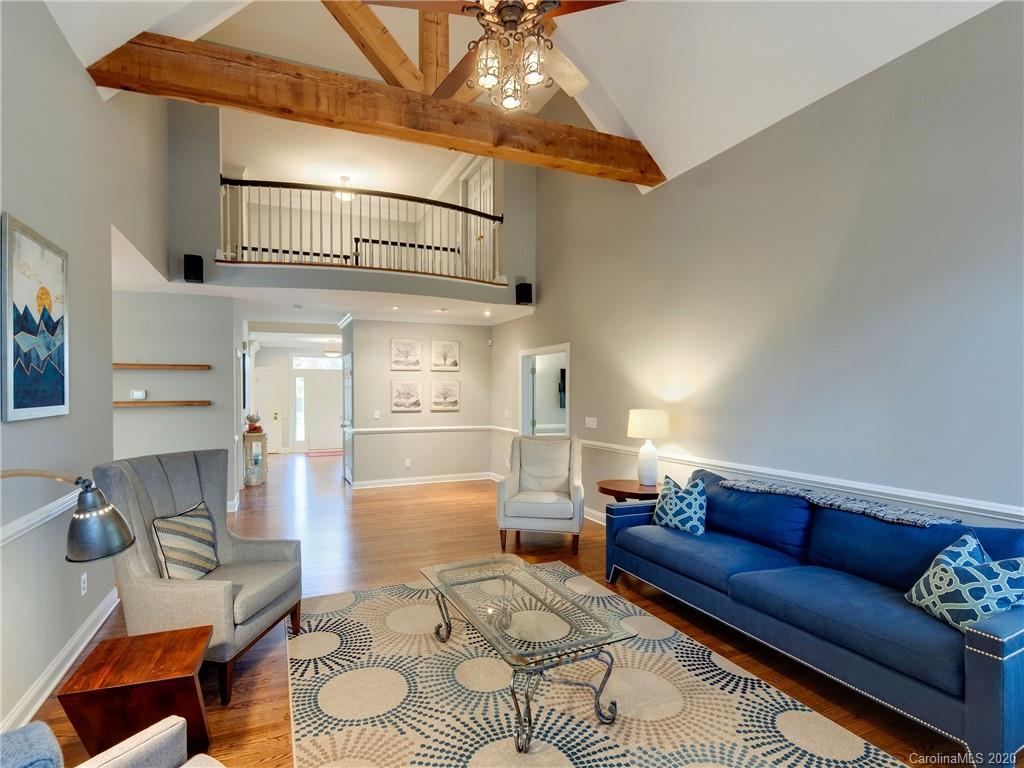 1612 Stevens Ridge Road Matthews, NC 28105 - Photo 13 of 44 a living room with furniture and a chandelier