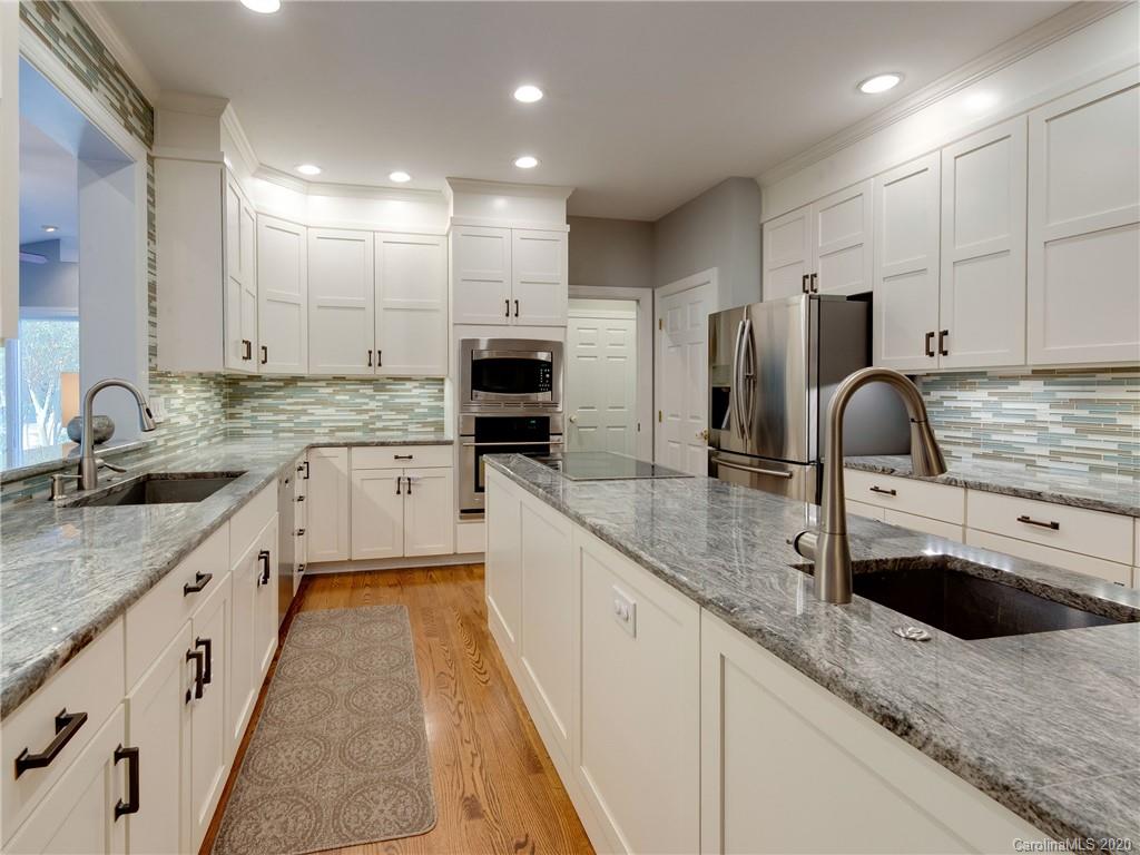 1612 Stevens Ridge Road Matthews, NC 28105 - Photo 18 of 44 a kitchen with stainless steel appliances granite countertop a sink stove and cabinets