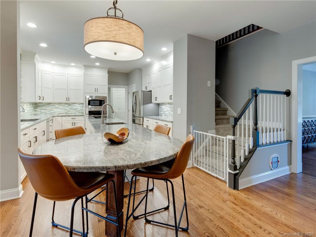 1612 Stevens Ridge Road Matthews, NC 28105 - Photo 19 of 44 a view of a dining room with furniture and wooden floor