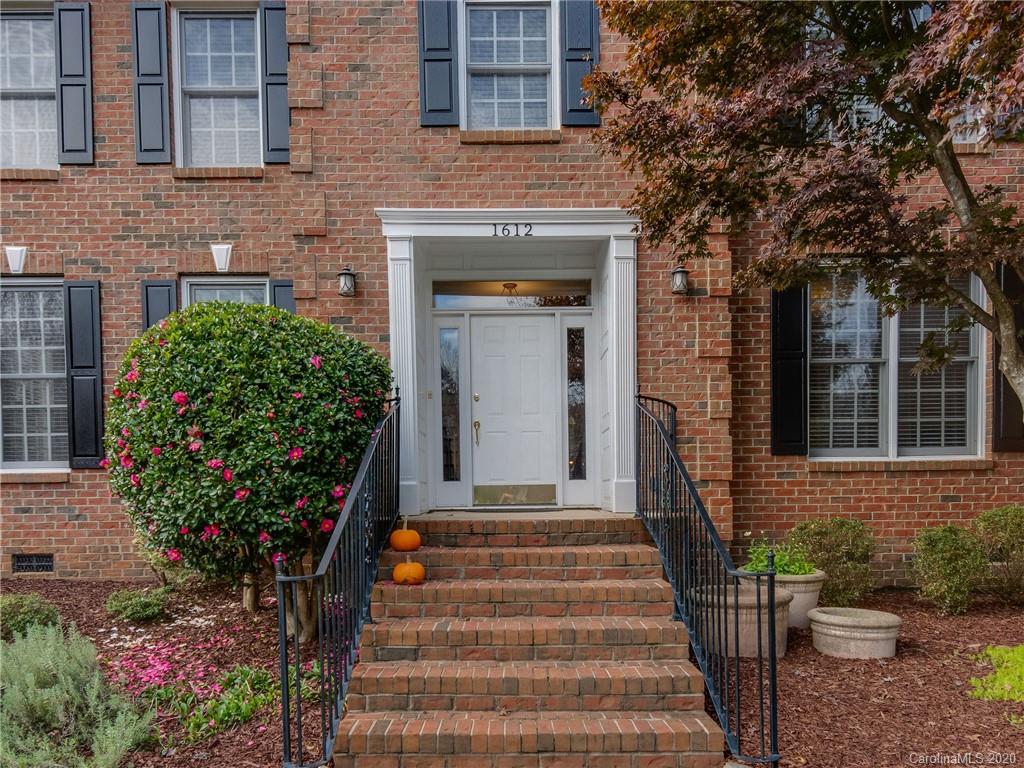1612 Stevens Ridge Road Matthews, NC 28105 - Photo 3 of 44 a front view of a house with a garden