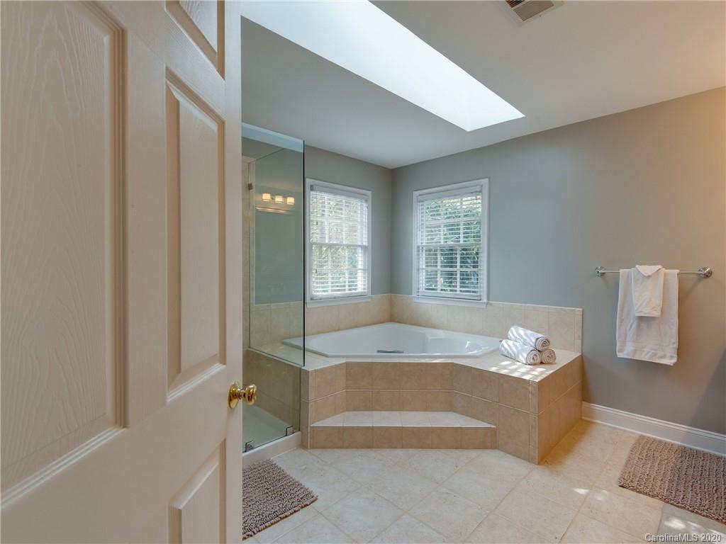 1612 Stevens Ridge Road Matthews, NC 28105 - Photo 28 of 44 a spacious bathroom with a tub shower and a window