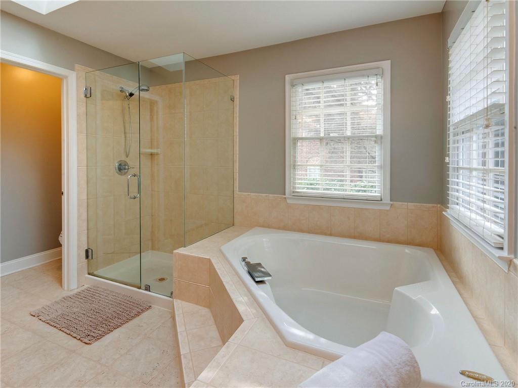 1612 Stevens Ridge Road Matthews, NC 28105 - Photo 30 of 44 a bathroom with a bathtub and shower