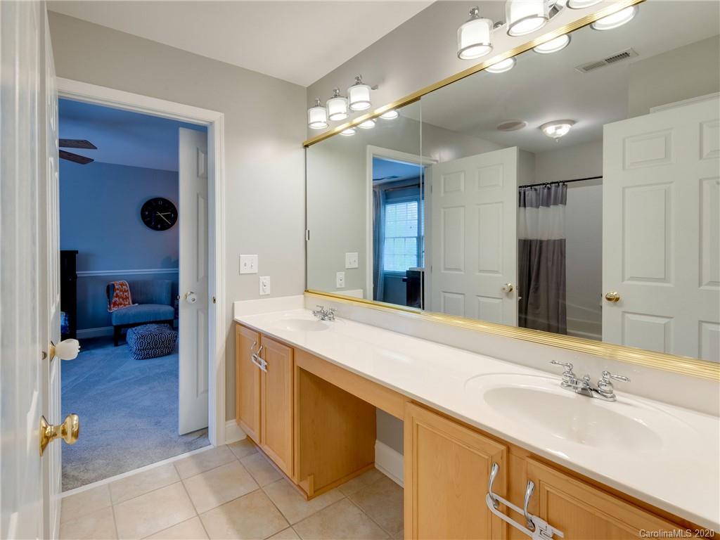 1612 Stevens Ridge Road Matthews, NC 28105 - Photo 32 of 44 a spacious bathroom with a sink a vanity and a large mirror