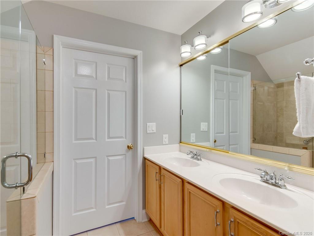 1612 Stevens Ridge Road Matthews, NC 28105 - Photo 37 of 44 a bathroom with a double vanity sink and mirror