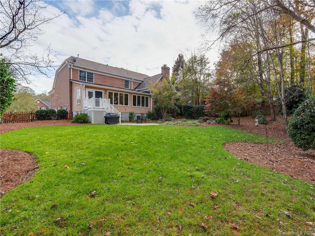 1612 Stevens Ridge Road Matthews, NC 28105 - Photo 44 of 44 a view of a house with a big yard and large trees