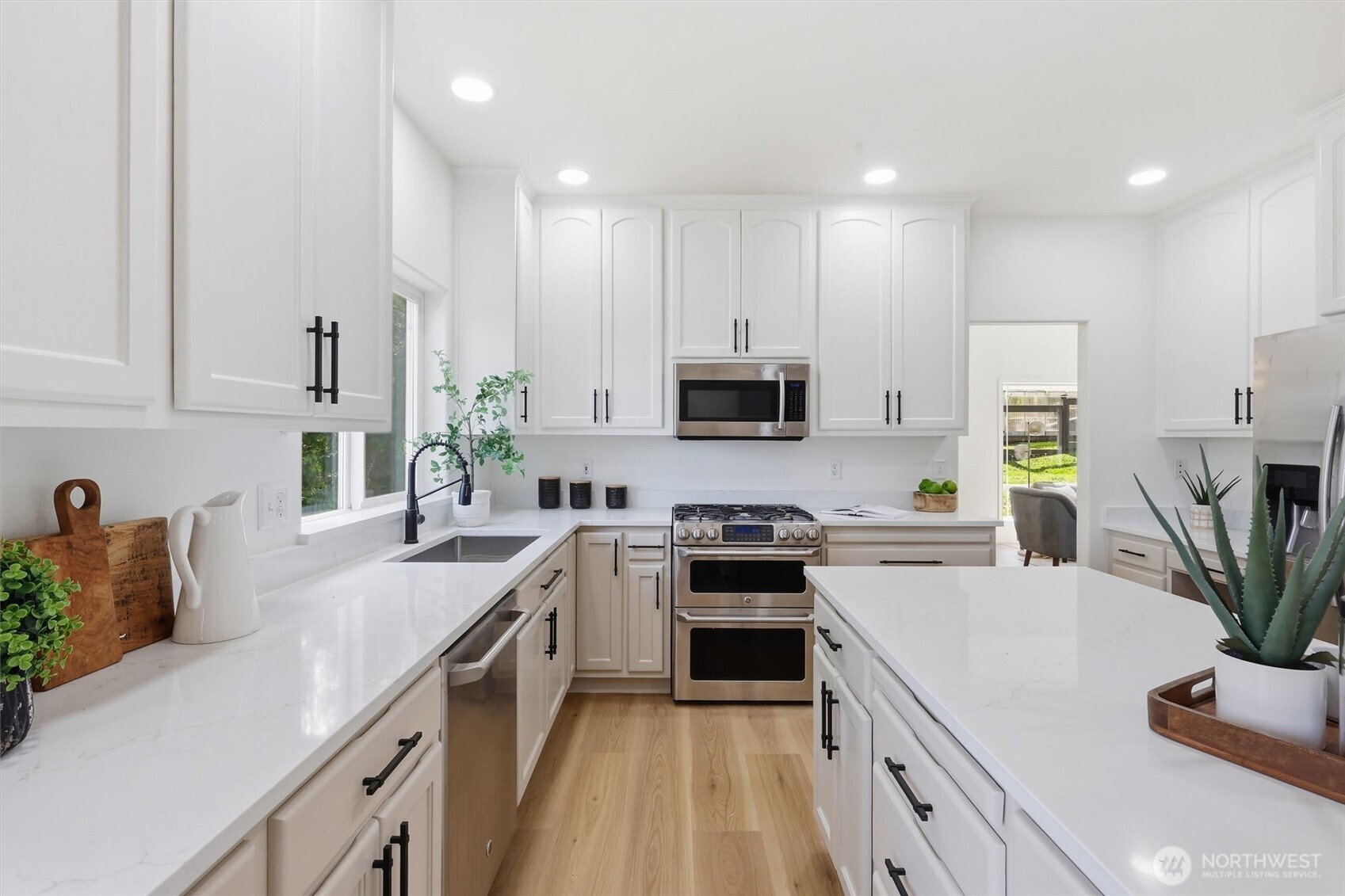 5523 East Wishon Road Snohomish, WA 98290 - Photo 13 of 39 a kitchen with white cabinets and appliances