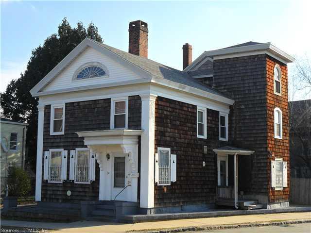 a view of a brick house with many windows