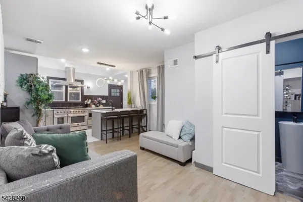 a living room with furniture and kitchen view