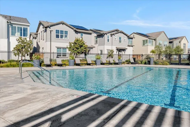 a view of residential houses with outdoor space and swimming pool