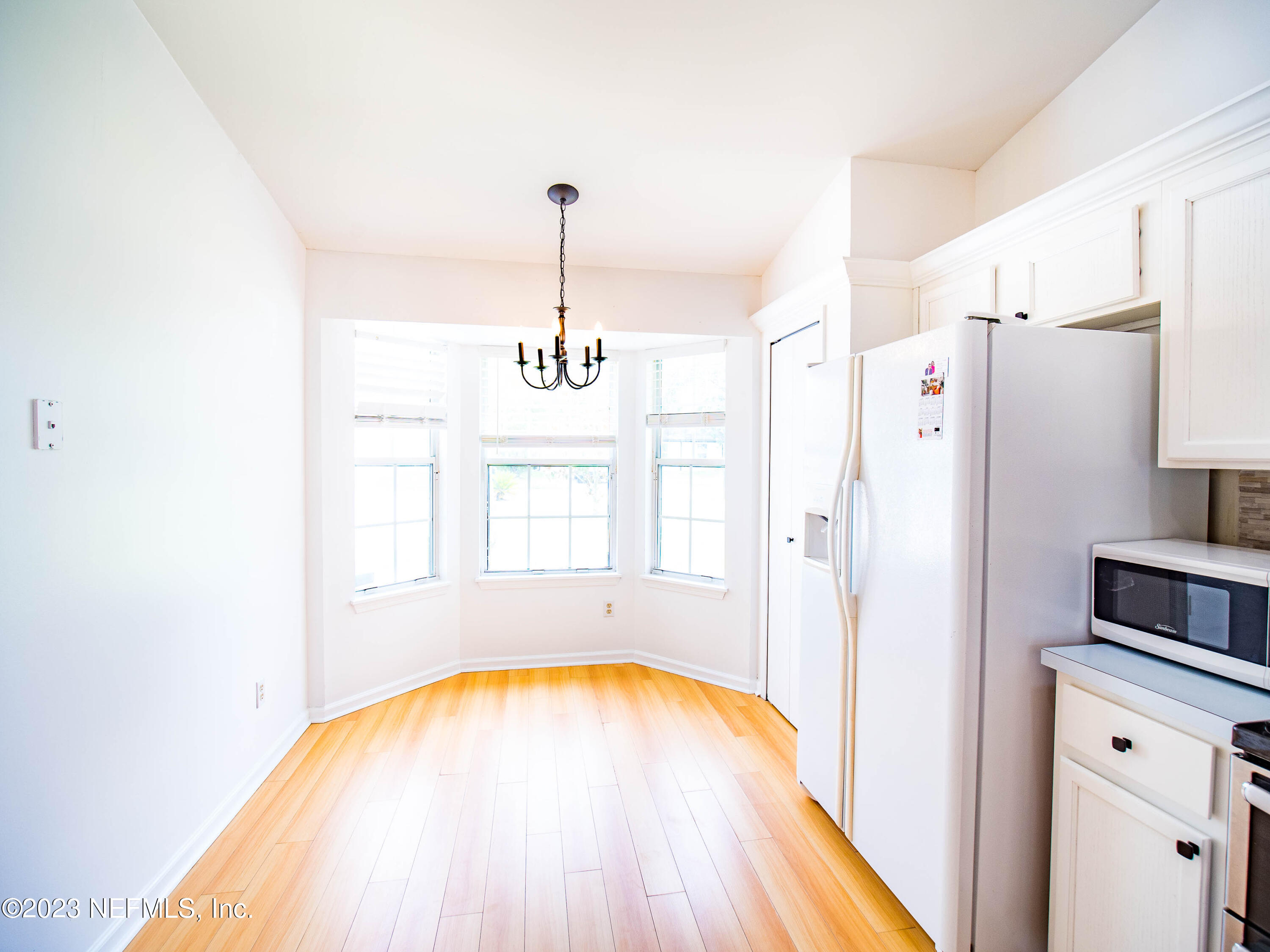 3252 Dowitcher Lane Orange Park, FL 32065 - Photo 11 of 25 a view of a kitchen with a cabinet and a ceiling fan