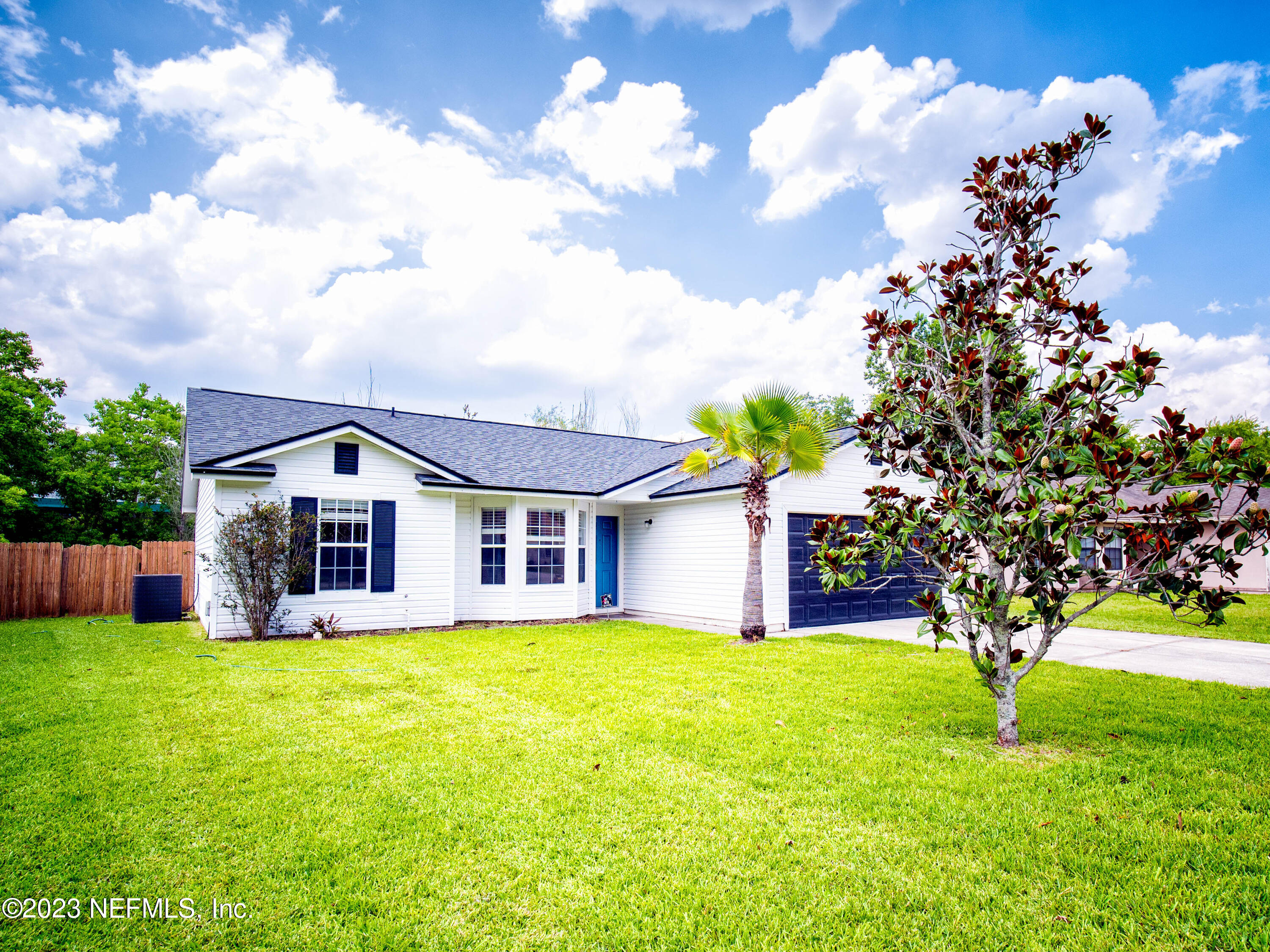 3252 Dowitcher Lane Orange Park, FL 32065 - Photo 2 of 25 a view of a house with a big yard and large tree