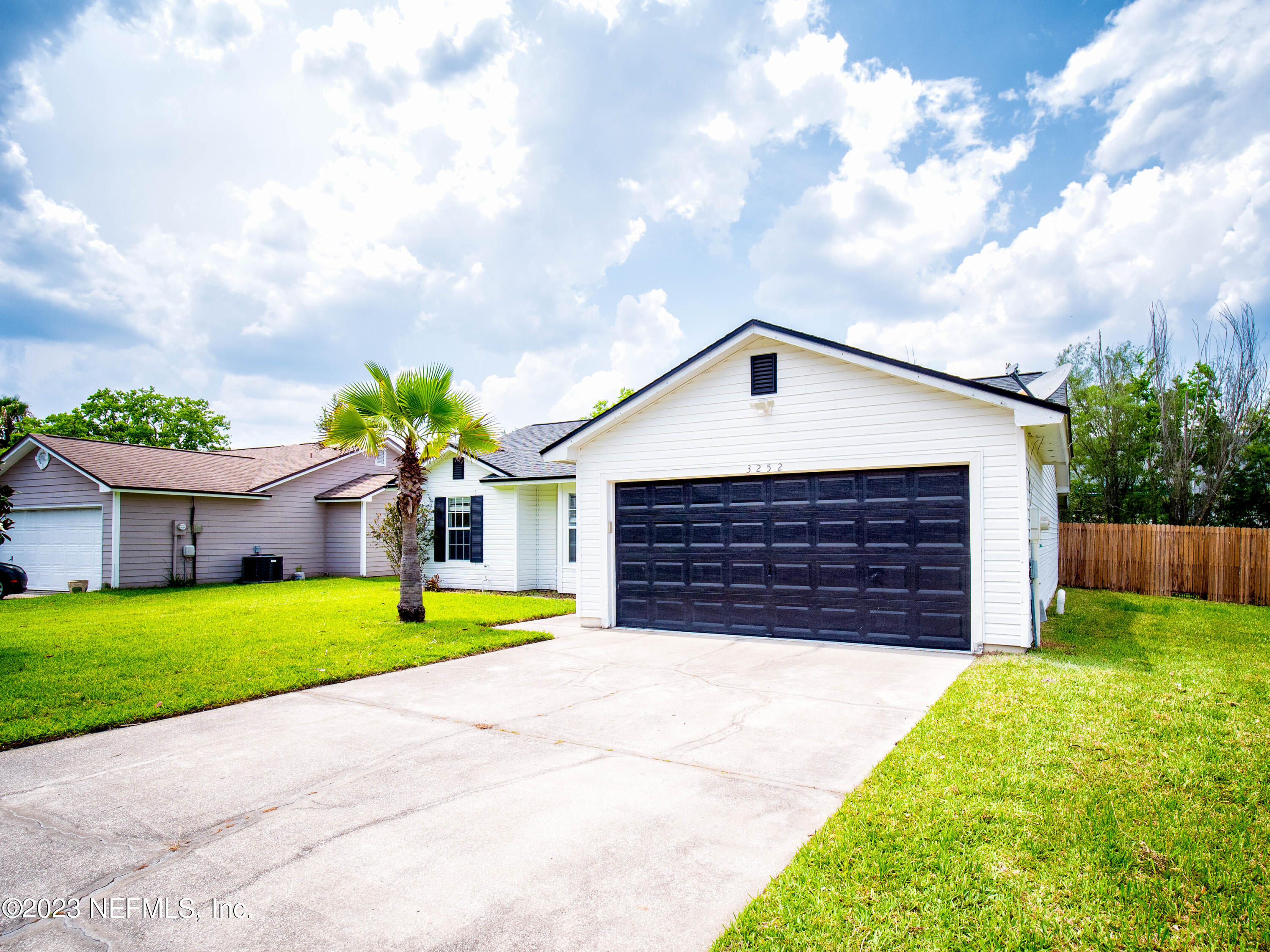 3252 Dowitcher Lane Orange Park, FL 32065 - Photo 3 of 25 a front view of house with yard and garage