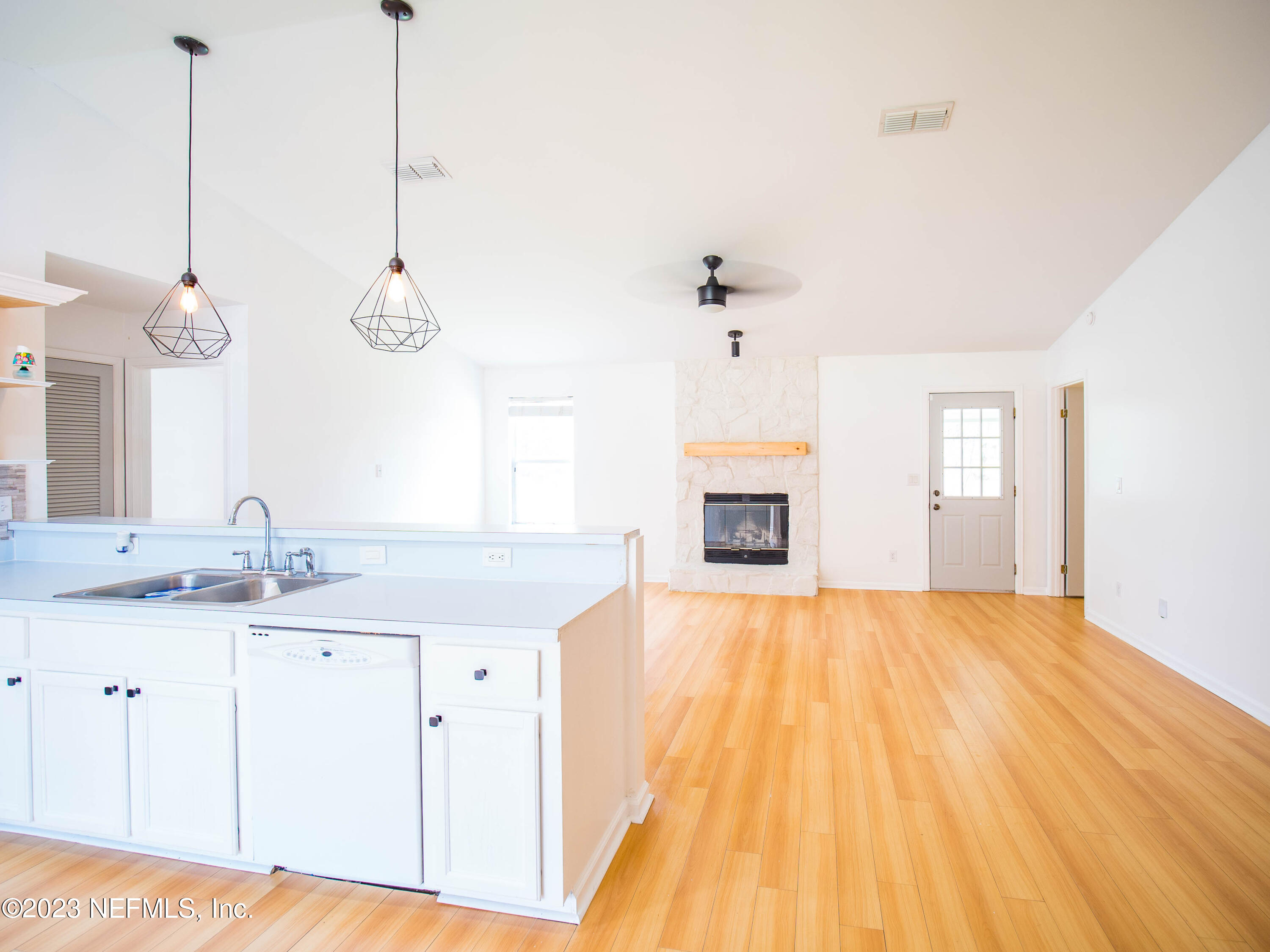 3252 Dowitcher Lane Orange Park, FL 32065 - Photo 6 of 25 a view of a kitchen sink and dishwasher with wooden floor