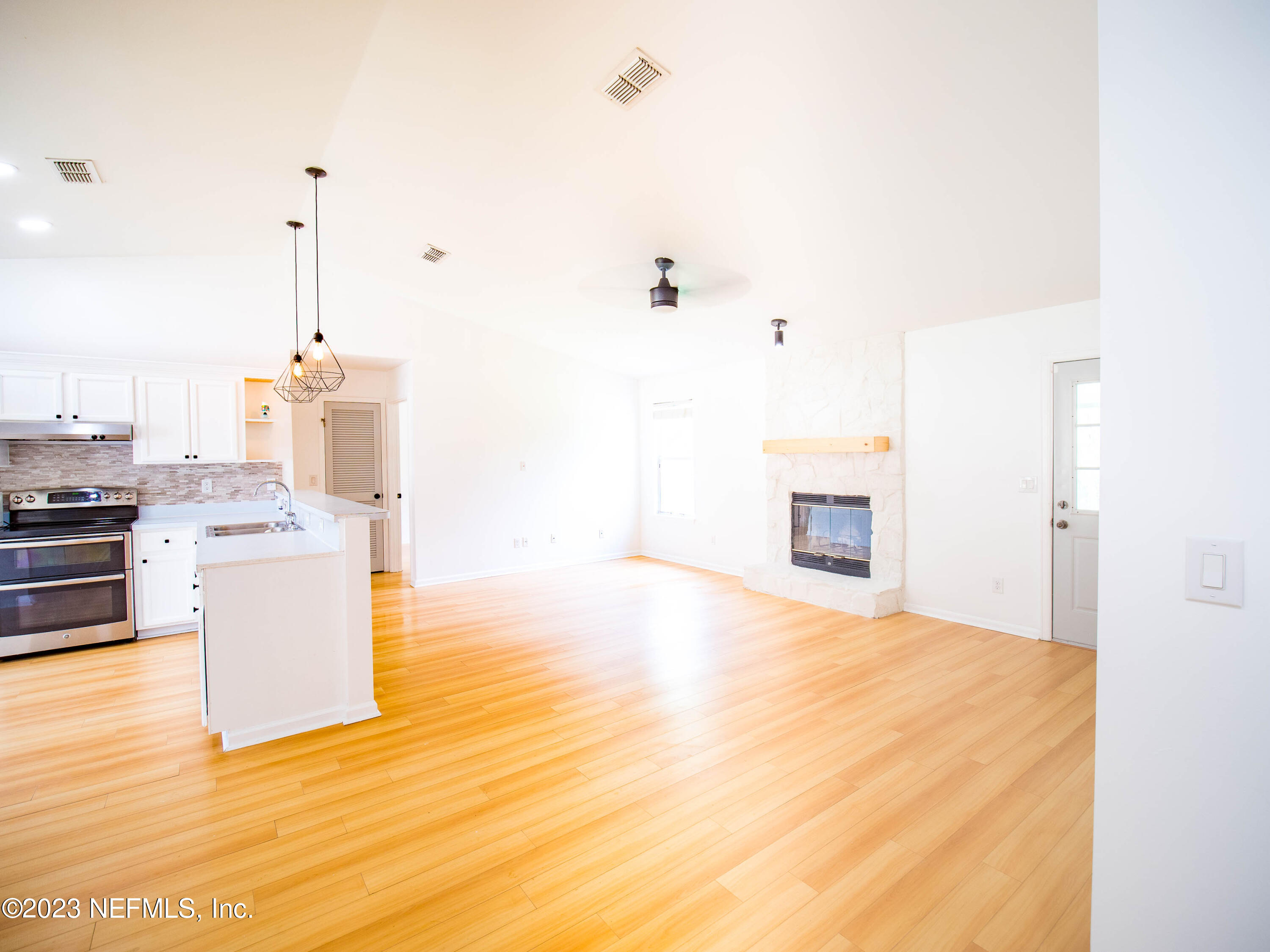 3252 Dowitcher Lane Orange Park, FL 32065 - Photo 8 of 25 a view of kitchen and hall with wooden floor