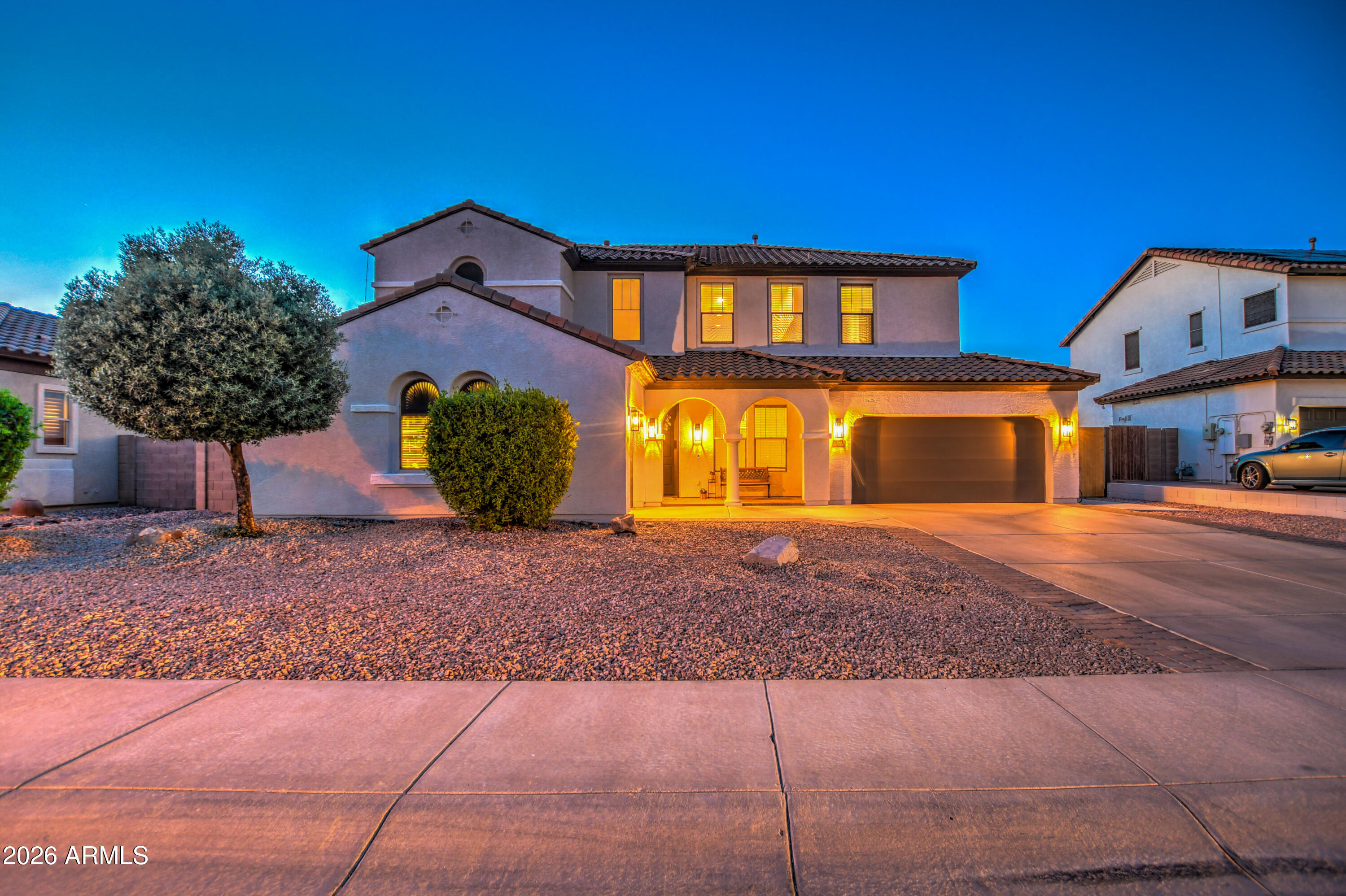 3078 East Muirfield Street Gilbert, AZ 85298 - Photo 2 of 92 a front view of a house with garden