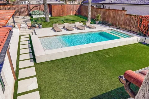 swimming pool view with a seating space