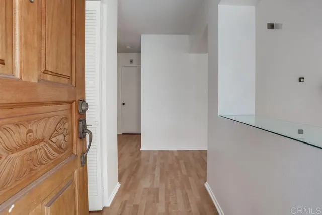 a view of a hallway with wooden floor