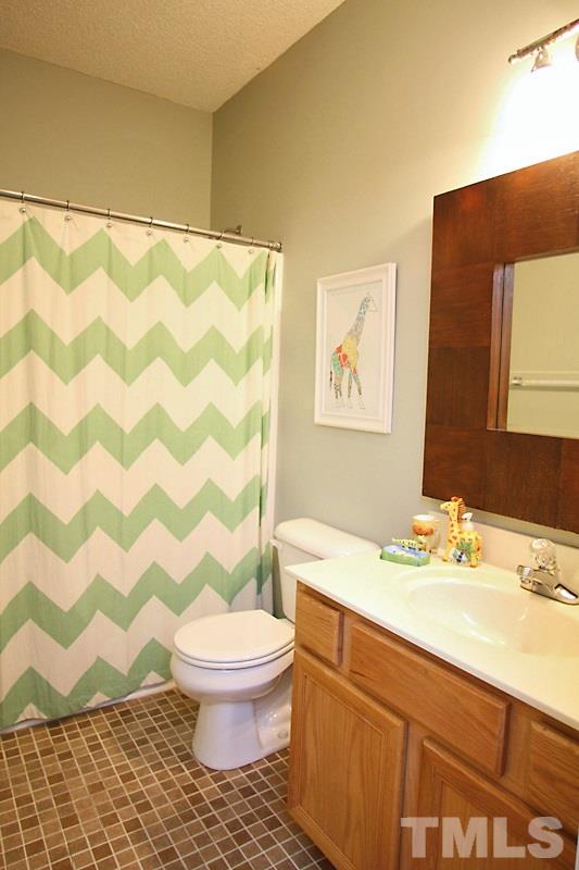1002 Shackleton Road Apex, NC 27502 - Photo 12 of 19 Hall bathroom with tiled flooring