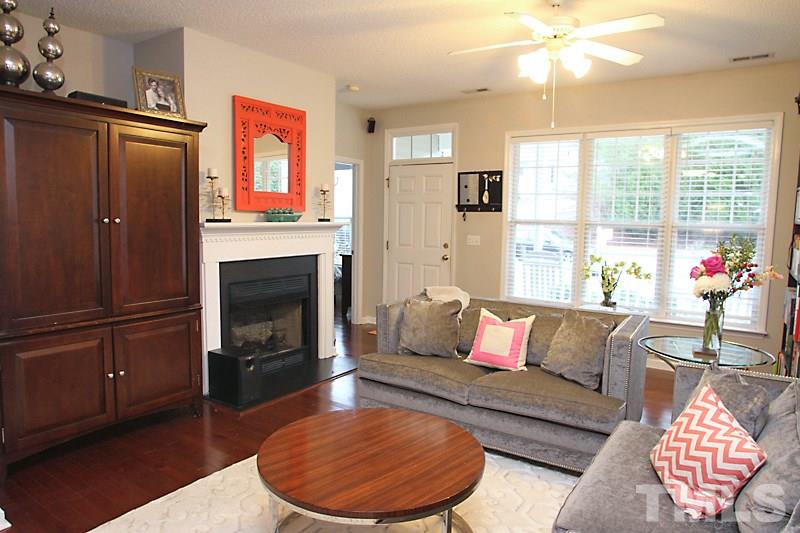 Welcoming living room with gas fireplace and open to dining area
