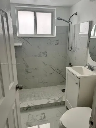 a bathroom with a sink a toilet and a mirror
